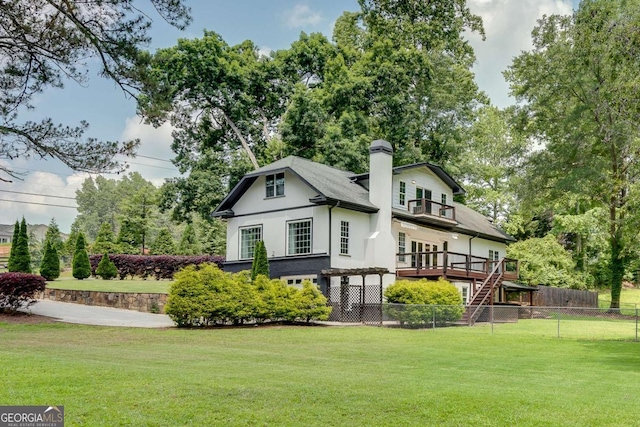 14440 Cogburn Rd, Alpharetta, GA 30004 - back of property with a wooden deck, a chimney, and stairs