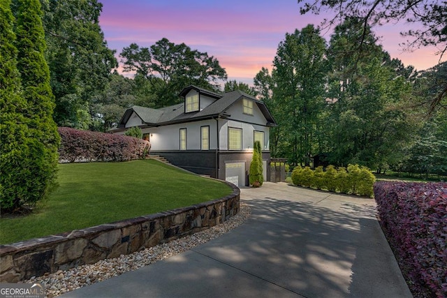 14440 Cogburn Rd, Alpharetta, GA 30004 - view of side of property featuring concrete driveway, stucco siding, an attached garage, and a lawn
