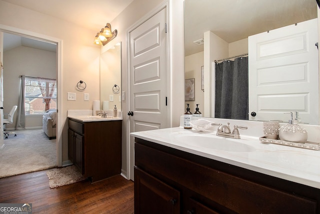 817 Nevis Way, Mcdonough, GA 30253 - bathroom featuring vanity, wood finished floors, connected bathroom, and baseboards
