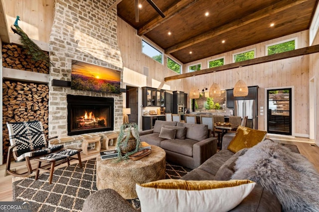 719 Ripshin Mountain Rd, Blue Ridge, GA 30513 - living area with high vaulted ceiling, wood finished floors, wooden ceiling with exposed beams, and a fireplace