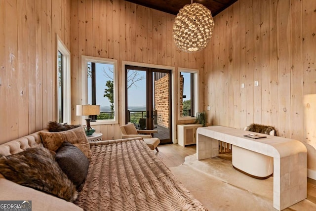 719 Ripshin Mountain Rd, Blue Ridge, GA 30513 - bedroom featuring a towering ceiling, wood walls, access to exterior, and light wood-style floors