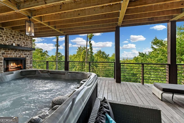 719 Ripshin Mountain Rd, Blue Ridge, GA 30513 - deck featuring a hot tub and an outdoor brick fireplace
