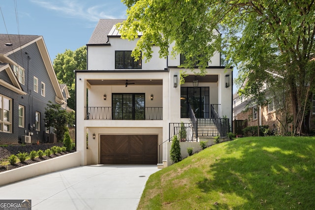 555 Orme Cir NE, Atlanta, GA 30306 - contemporary home with stucco siding, driveway, a front yard, and a garage