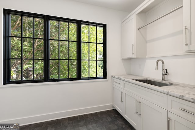 555 Orme Cir NE, Atlanta, GA 30306 - kitchen featuring a sink, plenty of natural light, baseboards, and white cabinets