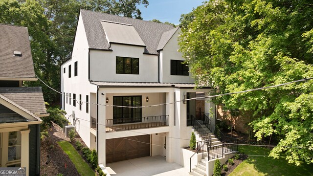 555 Orme Cir NE, Atlanta, GA 30306 - view of front facade featuring roof with shingles, stucco siding, stairway, a standing seam roof, and metal roof