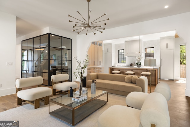 555 Orme Cir NE, Atlanta, GA 30306 - living room featuring light wood-style flooring, a chandelier, baseboards, and recessed lighting