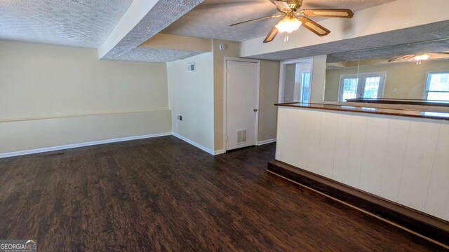 2015 Corners Cir, Lithonia, GA 30058 - unfurnished living room with dark wood-type flooring, a textured ceiling, and a ceiling fan