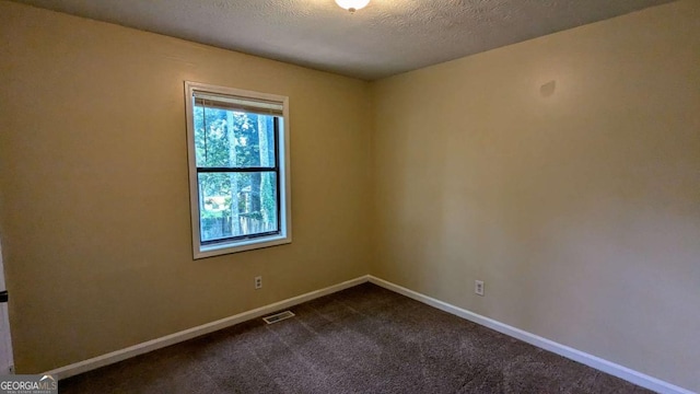 2015 Corners Cir, Lithonia, GA 30058 - unfurnished room with dark carpet and a textured ceiling