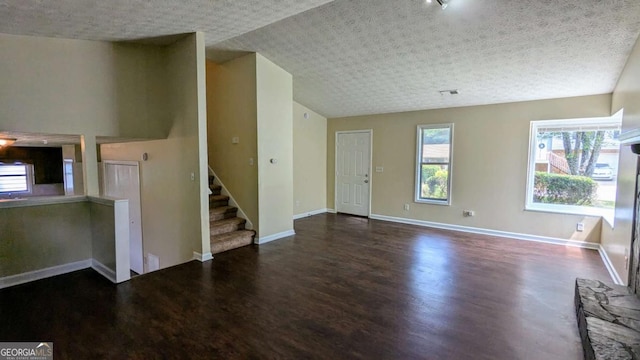 2015 Corners Cir, Lithonia, GA 30058 - unfurnished living room with wood finished floors, stairs, and vaulted ceiling