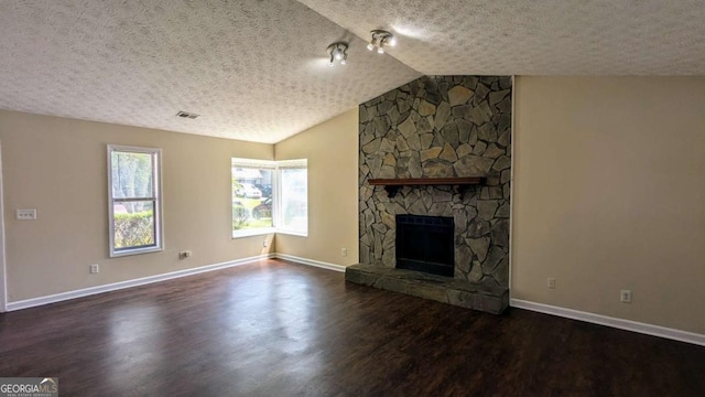 2015 Corners Cir, Lithonia, GA 30058 - unfurnished living room with a textured ceiling, wood finished floors, a fireplace, and vaulted ceiling