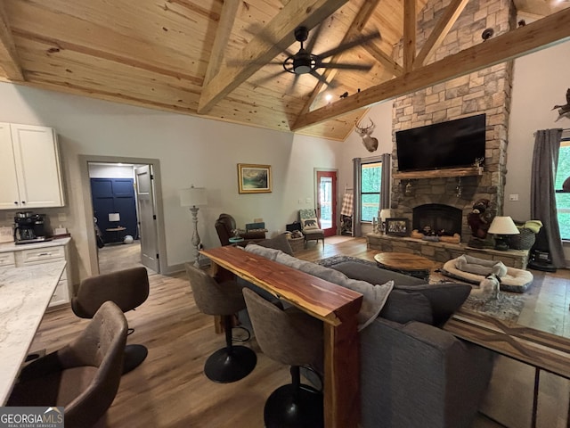2726 Turkey Trot, Hiawassee, GA 30546 - living room with wood finished floors, ceiling fan, wood ceiling with exposed beams, a fireplace, and healthy amount of natural light