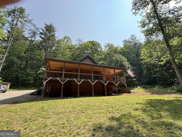 2726 Turkey Trot, Hiawassee, GA 30546 - back of property with a lawn, a deck, a view of trees, and a chimney