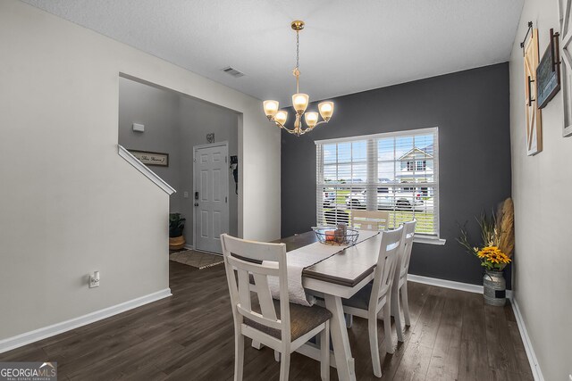 26 NE Sunflower Cir, Ludowici, GA 31316 - dining room with a chandelier, dark wood-type flooring, and baseboards