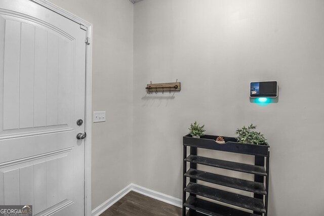 26 NE Sunflower Cir, Ludowici, GA 31316 - doorway with dark wood-style floors and baseboards