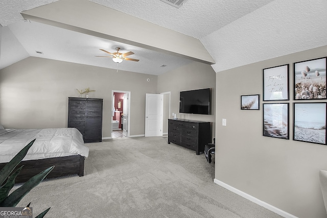 26 NE Sunflower Cir, Ludowici, GA 31316 - bedroom featuring vaulted ceiling, a textured ceiling, baseboards, light colored carpet, and connected bathroom