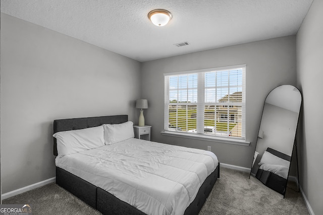 26 NE Sunflower Cir, Ludowici, GA 31316 - carpeted bedroom featuring baseboards and a textured ceiling
