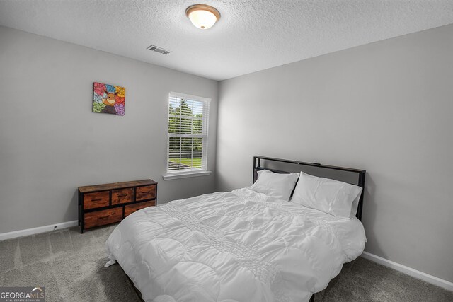 26 NE Sunflower Cir, Ludowici, GA 31316 - bedroom featuring carpet, a textured ceiling, and baseboards