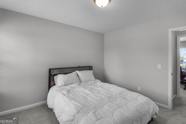 26 NE Sunflower Cir, Ludowici, GA 31316 - bedroom with carpet, baseboards, and a textured ceiling
