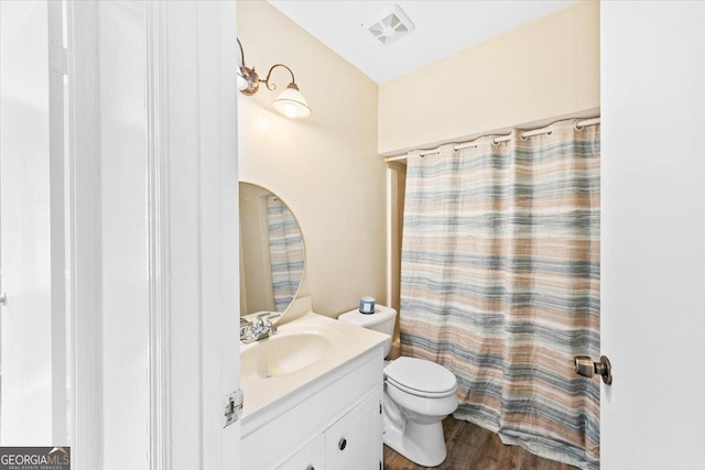 437 Edgewater Cir, Macon, GA 31220 - full bath with vanity, toilet, wood finished floors, and a shower with shower curtain