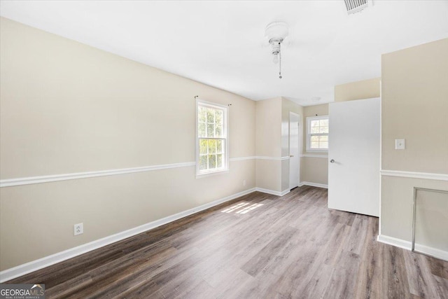 437 Edgewater Cir, Macon, GA 31220 - empty room featuring healthy amount of natural light, wood finished floors, and baseboards