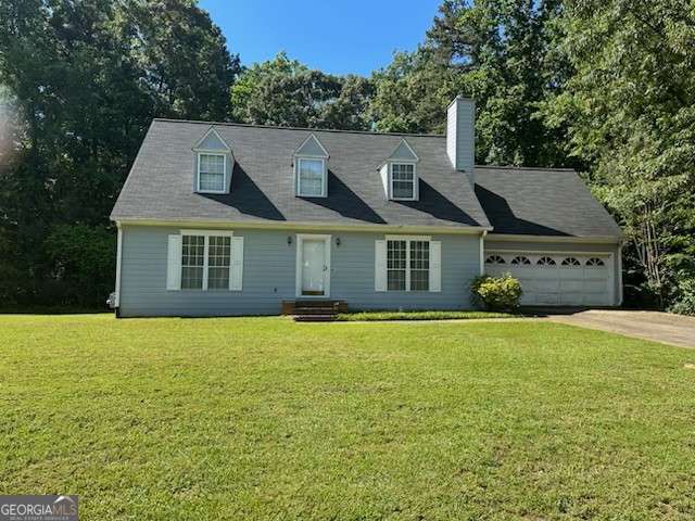 1481 Yates Cv, Lawrenceville, GA 30043 - cape cod home with a garage, a front yard, driveway, and a chimney