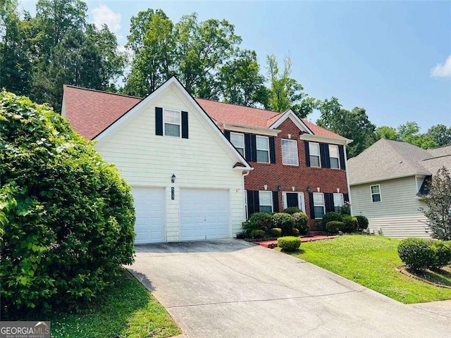 5123 Upper Elm St, Atlanta, GA 30349 - colonial inspired home with driveway, a front yard, and brick siding