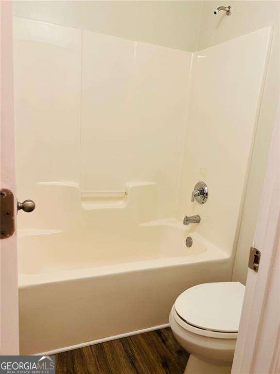5123 Upper Elm St, Atlanta, GA 30349 - full bathroom featuring wood finished floors, toilet, and bathtub / shower combination