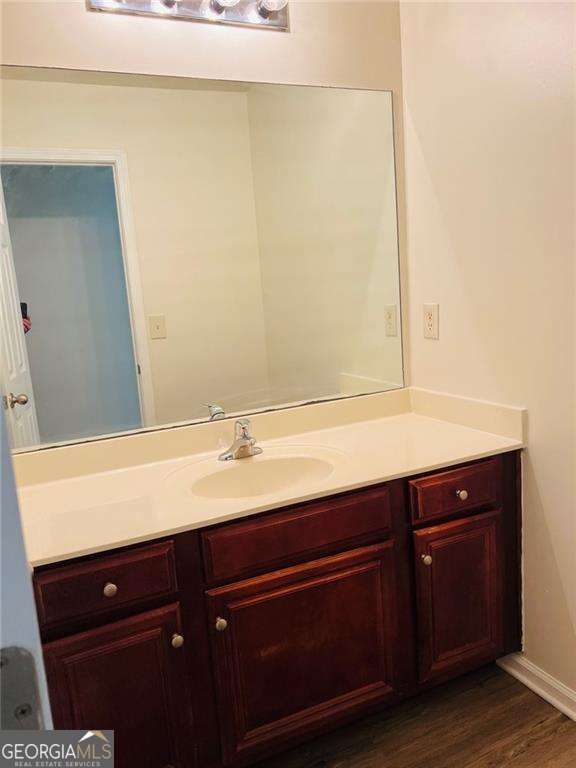 5123 Upper Elm St, Atlanta, GA 30349 - bathroom with vanity and wood finished floors