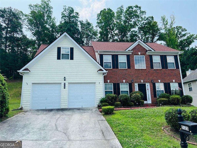5123 Upper Elm St, Atlanta, GA 30349 - colonial-style house with driveway, a front lawn, and brick siding