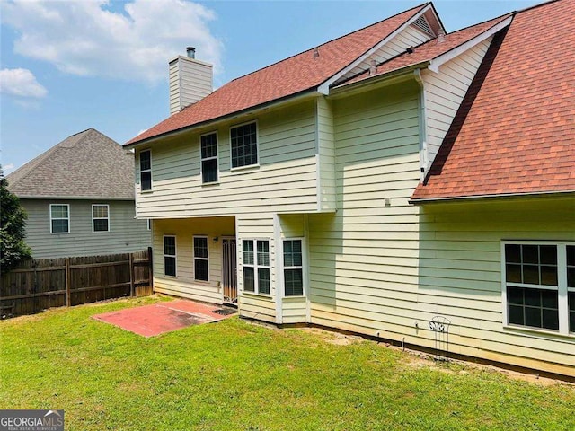 5123 Upper Elm St, Atlanta, GA 30349 - rear view of house with a chimney, a patio, and roof with shingles