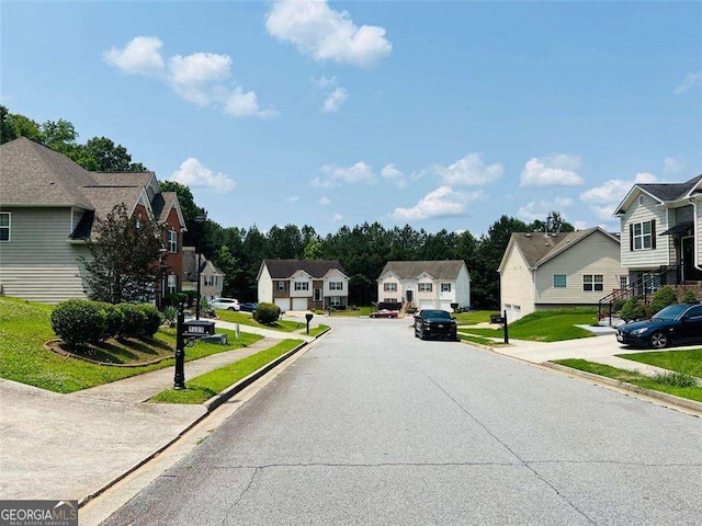 5123 Upper Elm St, Atlanta, GA 30349 - view of asphalt street featuring a residential view, curbs, and sidewalks