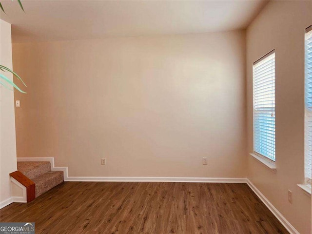 5123 Upper Elm St, Atlanta, GA 30349 - unfurnished room with dark wood-type flooring, baseboards, and stairway