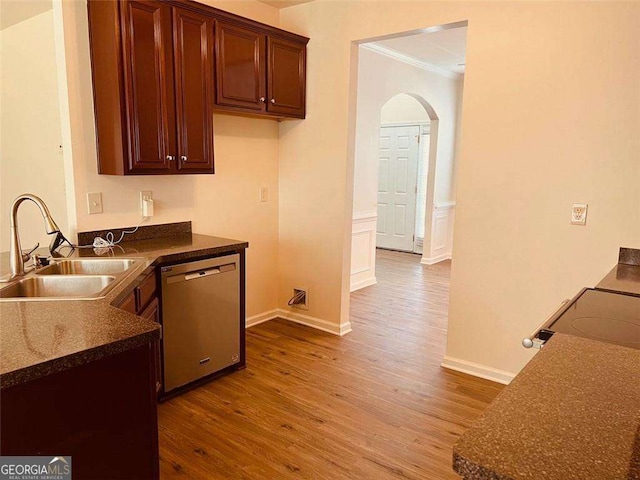 5123 Upper Elm St, Atlanta, GA 30349 - kitchen featuring stainless steel dishwasher, a sink, arched walkways, dark countertops, and dark wood finished floors