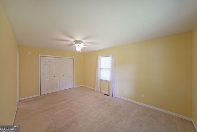 2394 Burch Cir NE, Brookhaven, GA 30319 - unfurnished bedroom with light colored carpet, baseboards, a closet, and a ceiling fan