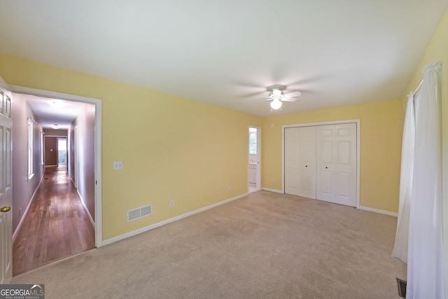 2394 Burch Cir NE, Brookhaven, GA 30319 - unfurnished bedroom featuring carpet floors, baseboards, multiple windows, and a closet