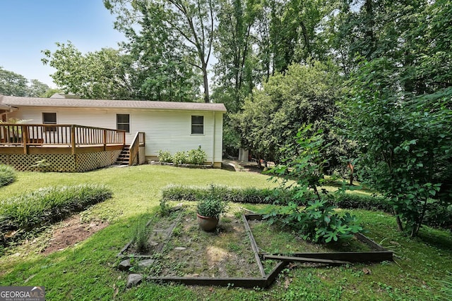 2394 Burch Cir NE, Brookhaven, GA 30319 - view of grassy yard with a garden and a deck