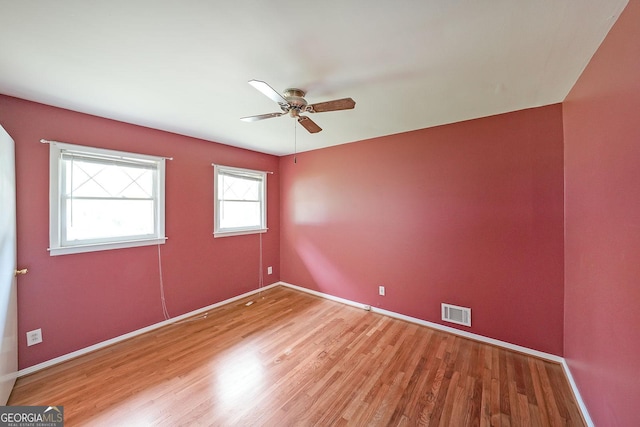 2394 Burch Cir NE, Brookhaven, GA 30319 - empty room with light wood finished floors, ceiling fan, and baseboards