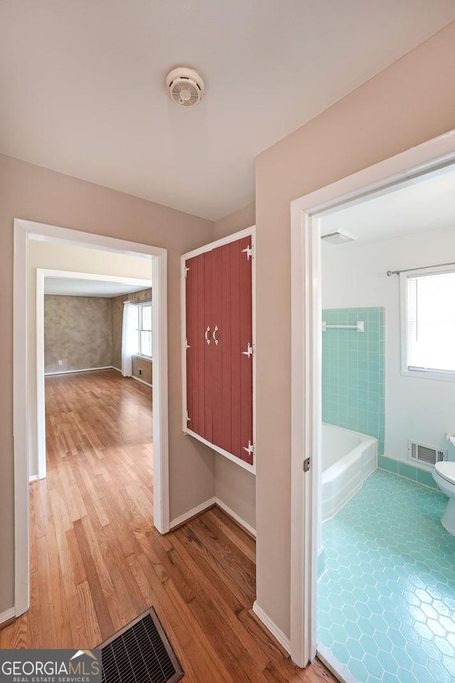 2394 Burch Cir NE, Brookhaven, GA 30319 - hall featuring plenty of natural light and wood finished floors