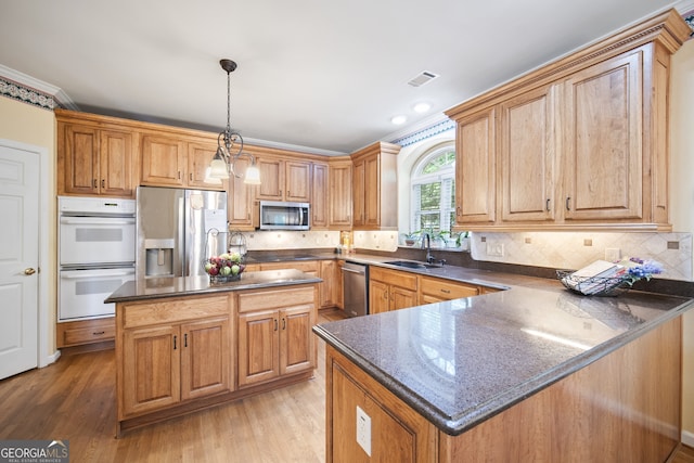 569 Fairway Dr, Woodstock, GA 30189 - kitchen featuring stainless steel appliances, a peninsula, decorative backsplash, a kitchen island, and light wood-style flooring