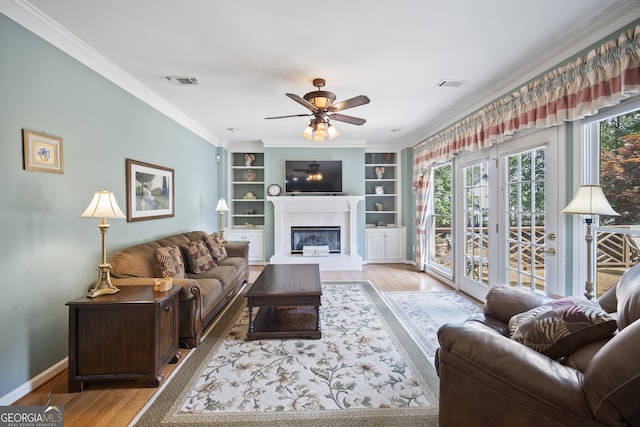 569 Fairway Dr, Woodstock, GA 30189 - living area featuring wood finished floors, plenty of natural light, ceiling fan, and ornamental molding