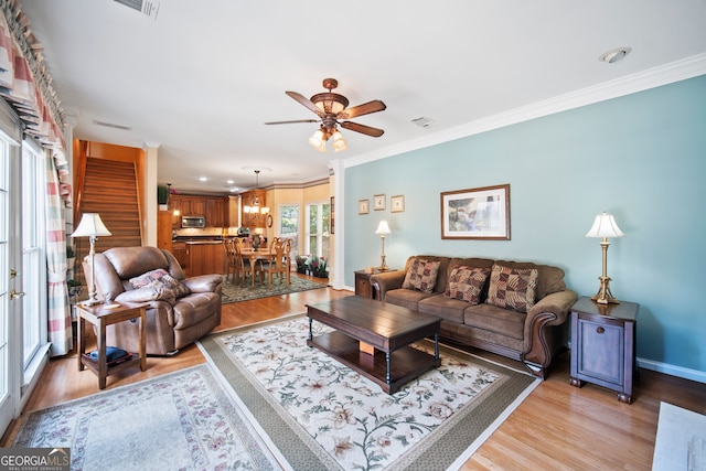 569 Fairway Dr, Woodstock, GA 30189 - living area with light wood finished floors, ceiling fan, and ornamental molding