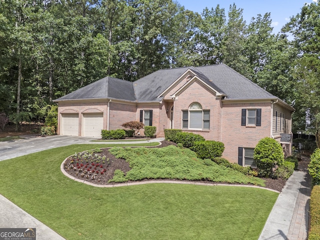 569 Fairway Dr, Woodstock, GA 30189 - view of front of home featuring brick siding, a front yard, concrete driveway, and a garage
