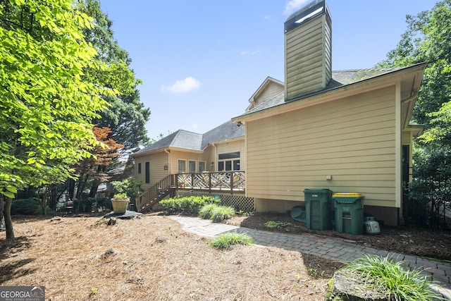 569 Fairway Dr, Woodstock, GA 30189 - rear view of house featuring a deck and a chimney