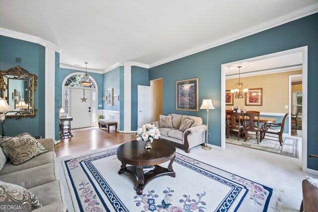 569 Fairway Dr, Woodstock, GA 30189 - living area with crown molding, a chandelier, and wood finished floors