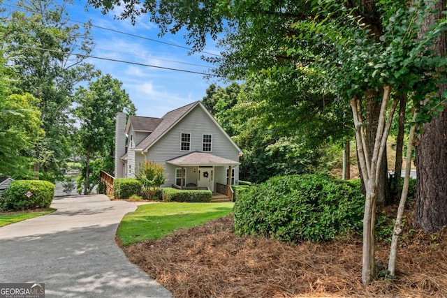 291 Thomas Dr, Eatonton, GA 31024 - view of front of property with a chimney, driveway, and covered porch