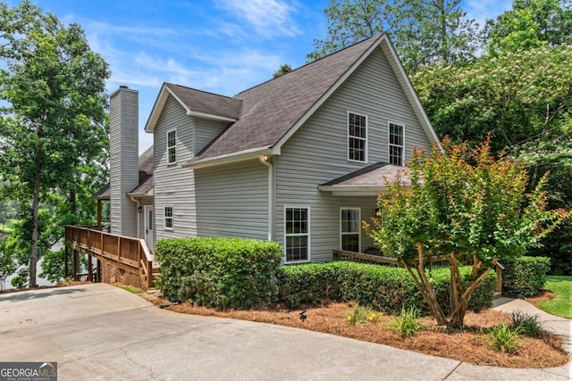 291 Thomas Dr, Eatonton, GA 31024 - view of side of property with a chimney and a shingled roof