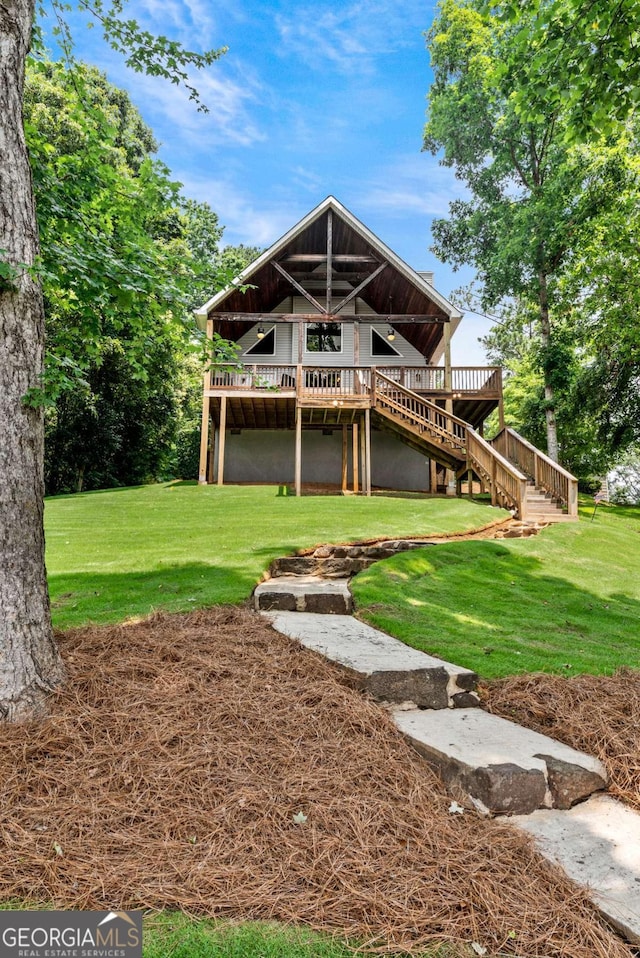 291 Thomas Dr, Eatonton, GA 31024 - rear view of house with stairway, a deck, and a lawn