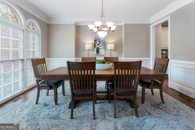 10135 High Falls Pointe, Johns Creek, GA 30022 - dining room featuring a chandelier, ornamental molding, a wainscoted wall, wood finished floors, and a decorative wall