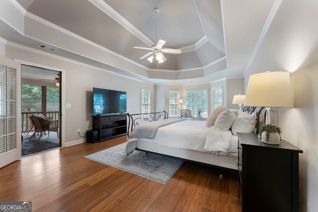 10135 High Falls Pointe, Johns Creek, GA 30022 - bedroom featuring a raised ceiling, wood finished floors, access to outside, baseboards, and crown molding