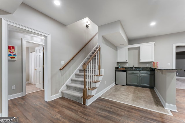 10135 High Falls Pointe, Johns Creek, GA 30022 - kitchen with dishwashing machine, dark wood-style floors, white cabinetry, a sink, and baseboards